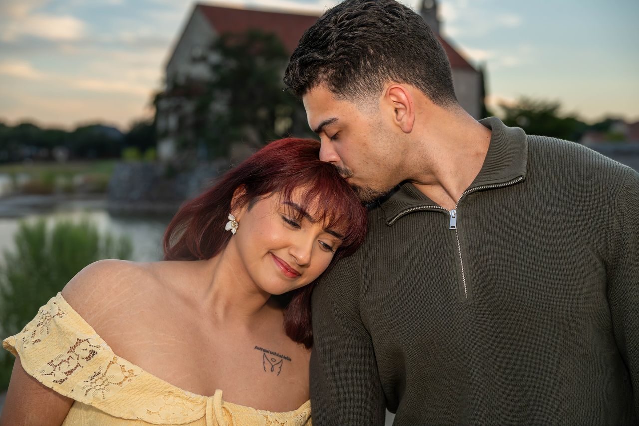 Luca kisses Ana on the forehead as she smiles