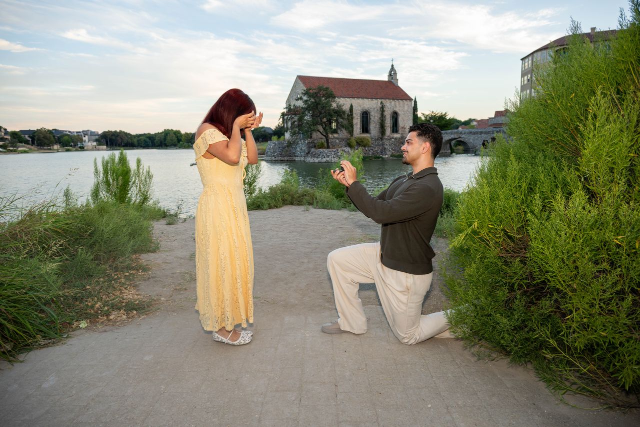 Ana covers her face as Luca kneels with the ring