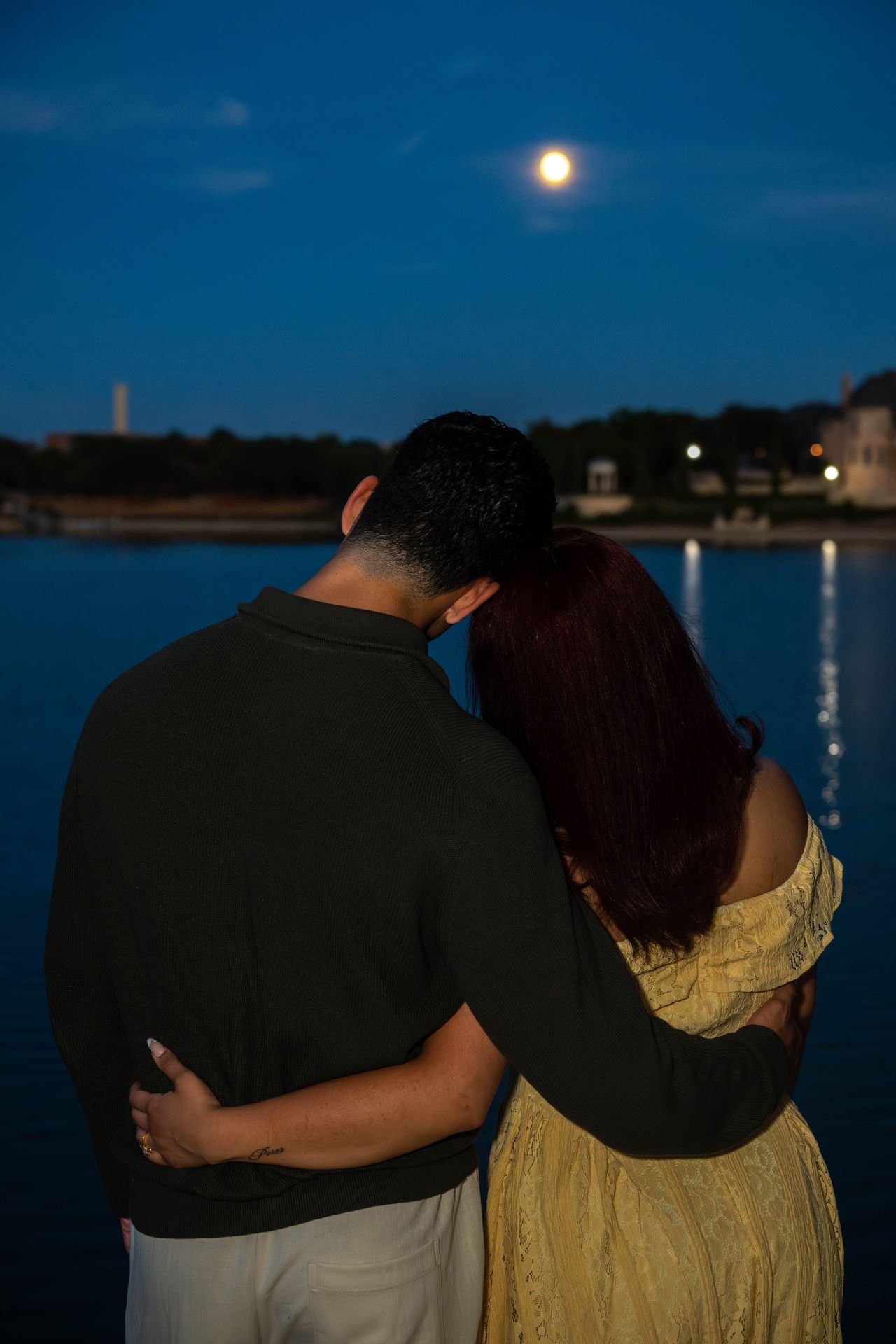 Luca and Ana embrace by the lake under the moon